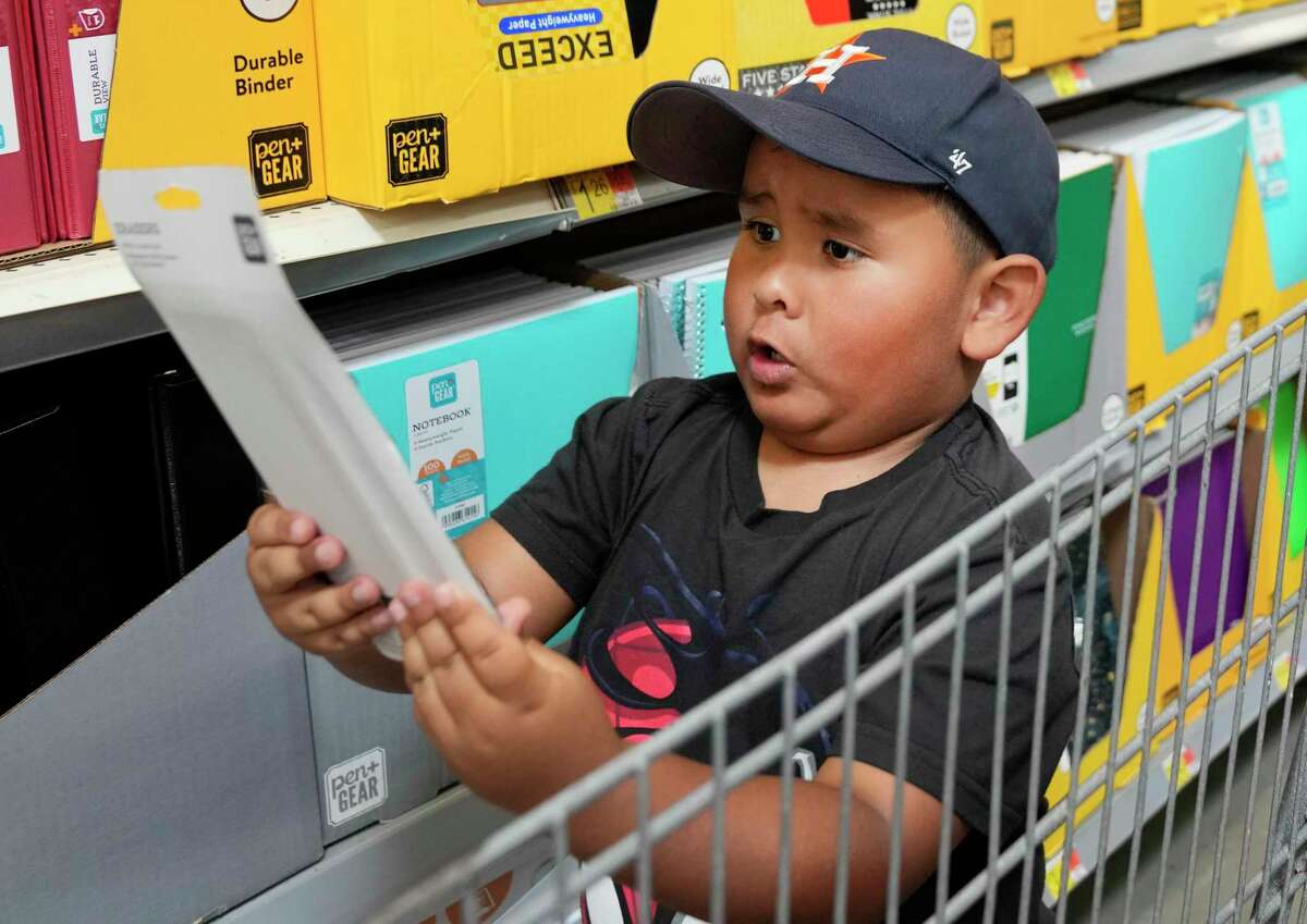 Kindergartener Joe Tolbert, 5, shops for school supplies with his dad, Micheal Tolbert, at Walmart, 1118 Silber Rd., Tuesday, Aug. 2, 2022, in Houston.