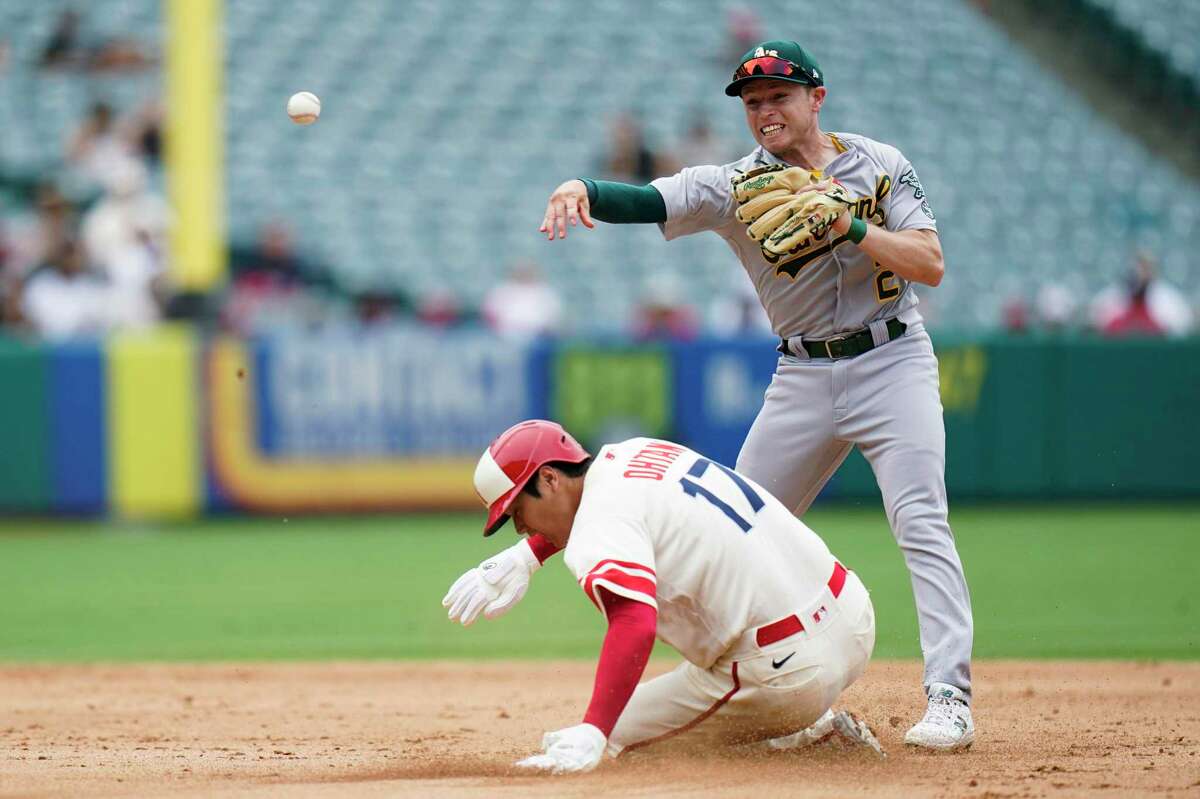 Oakland Athletics' Nick Allen throws to first base after forcing out Los Angeles Angels' Shohei Ohtani during the fifth inning of a baseball game Thursday, Aug. 4, 2022, in Anaheim, Calif. Luis Rengifo was safe at first. (AP Photo/Jae C. Hong)