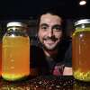 Alexander Angeloff ,owner of The Remedy's Cultured Cafe, on State Street in New Haven photographed with a selection of water kefir secondary ferments made with juices and herbs on August 4, 2022.