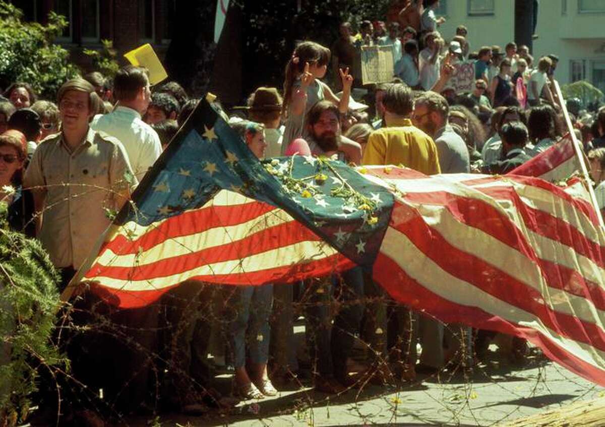 An American flag was draped over a barrier of barbed wire at People's Park Riot during an earlier protest.