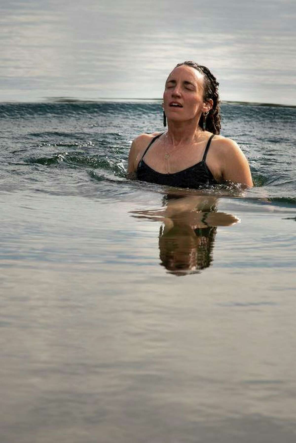 Nina Gordon-Kirsch takes a swim in Lower Highland Lake, the source of the Mokelumne River, at the finish of her hike and kayak of the river from Oakland to its headwaters in the Sierra, Friday, July 29, 2022.