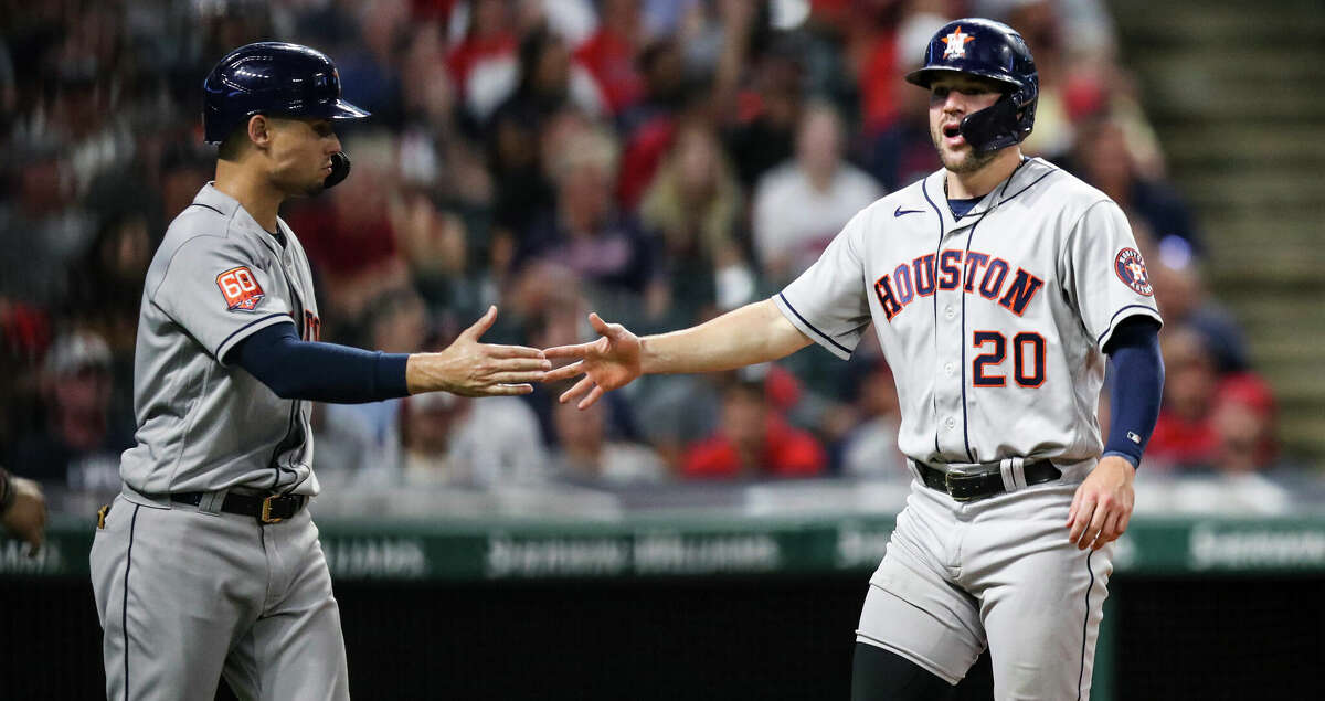 Aledmys Diaz #16 of the Houston Astros celebrates with Chas McCormick #20 after scoring on an RBI double by Marti­n Maldonado #15 in the top of the fifth inning during the game against the Cleveland Guardians at Progressive Field on August 4, 2022 in Cleveland, Ohio. (Photo by Lauren Bacho/Getty Images)