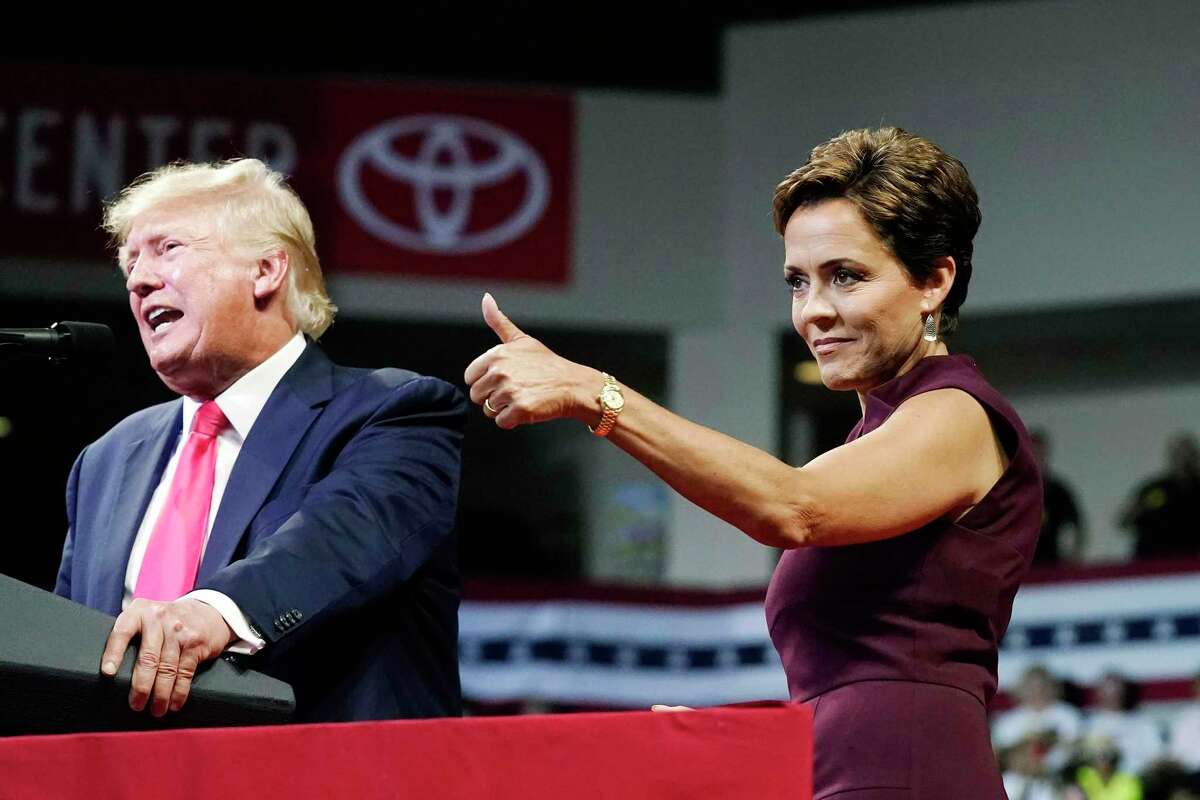 Arizona Republican candidate for governor, Kari Lake, gives a thumbs up to the crowd as former President Donald Trump speaks at a Save America rally Friday, July 22, 2022, in Prescott, Ariz. Lake narrowly won a primary this week.
