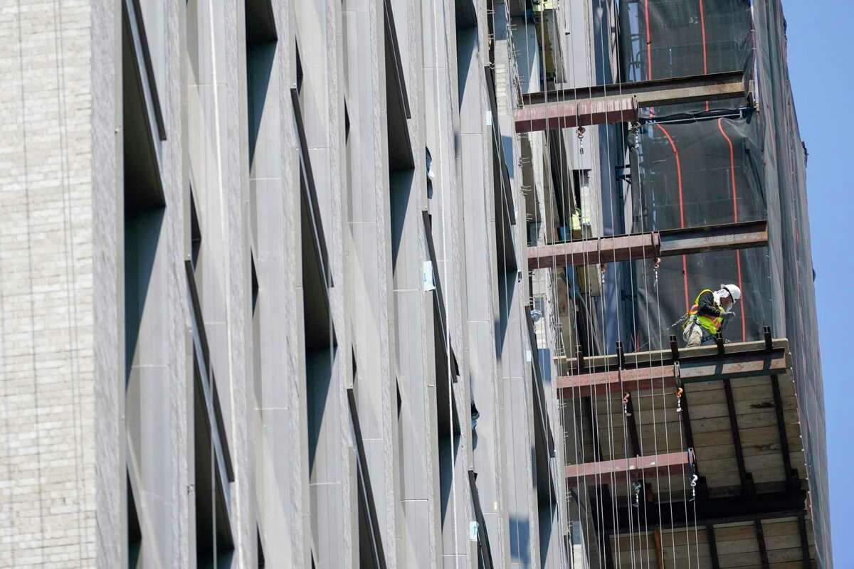 Construction workers is seen working on a high rise residential and commercial building under construction at the Essex Crossing development on the Lower East Side of Manhattan, Thursday, Aug. 4, 2022. On Friday, Aug. 5, the Labor Department delivers its July jobs report.