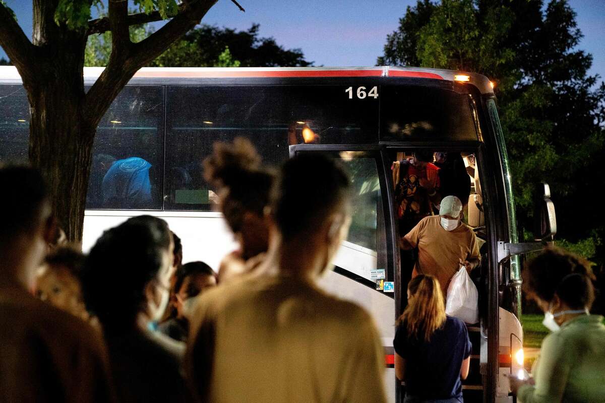 Migrants from Venezuela, who boarded a bus in Del Rio, Texas, disembark within view of the US Capitol in Washington, DC, on August 2, 2022. - Since April, Texas Governor Greg Abbott has ordered over 150 buses to carry approximately 4,500 migrants from Texas to Washington, DC, to highlight criticisms of US President Joe Bidens border policy. (Photo by Stefani Reynolds / AFP) (Photo by STEFANI REYNOLDS/AFP via Getty Images)