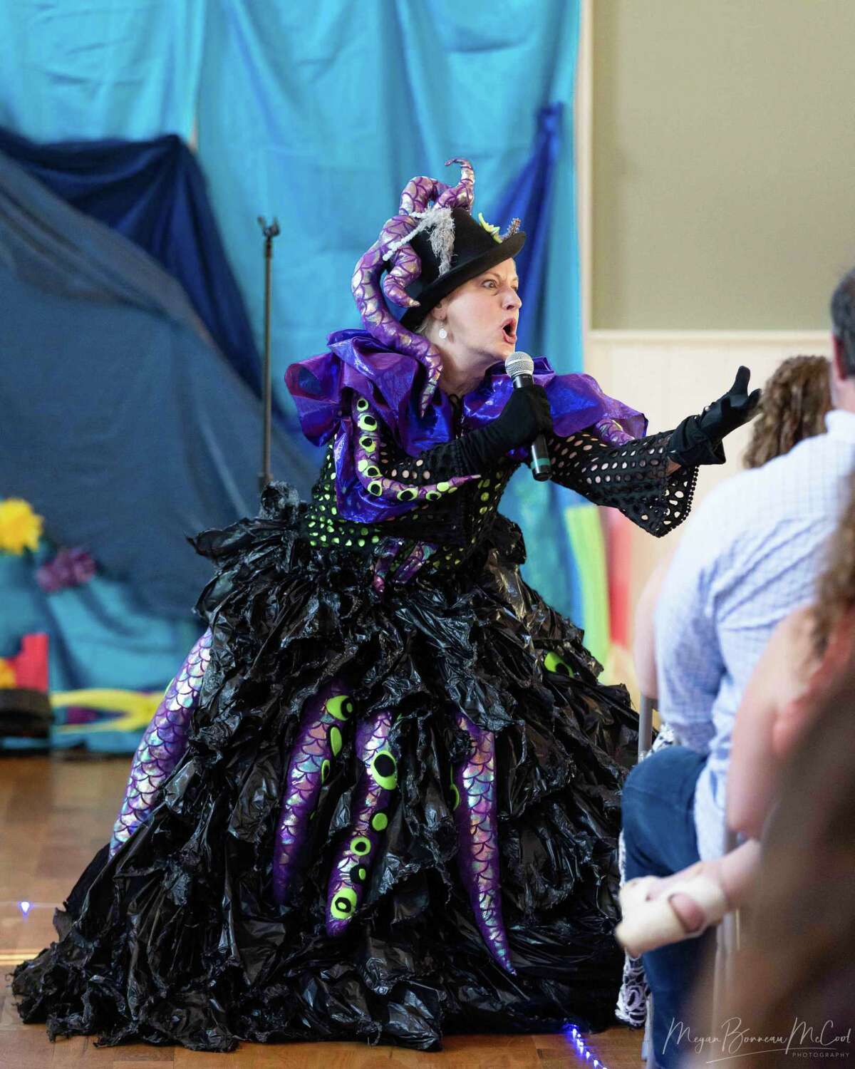 Ursula sings songs from New Paradigm Theatre Company’s production of “The Little Mermaid” at the Maritime Aquarium in Norwalk as part of a partnership between the two organizations. Her costume is made from black plastic bags.