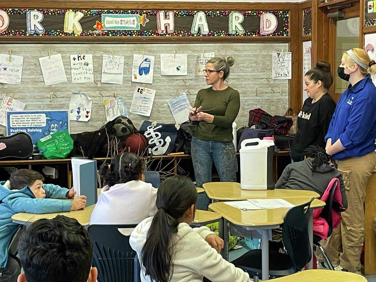 Members of New Paradigm Theatre Company and the Maritime Aquarium speak at a Norwalk school as part of a partnership between the two organizations.