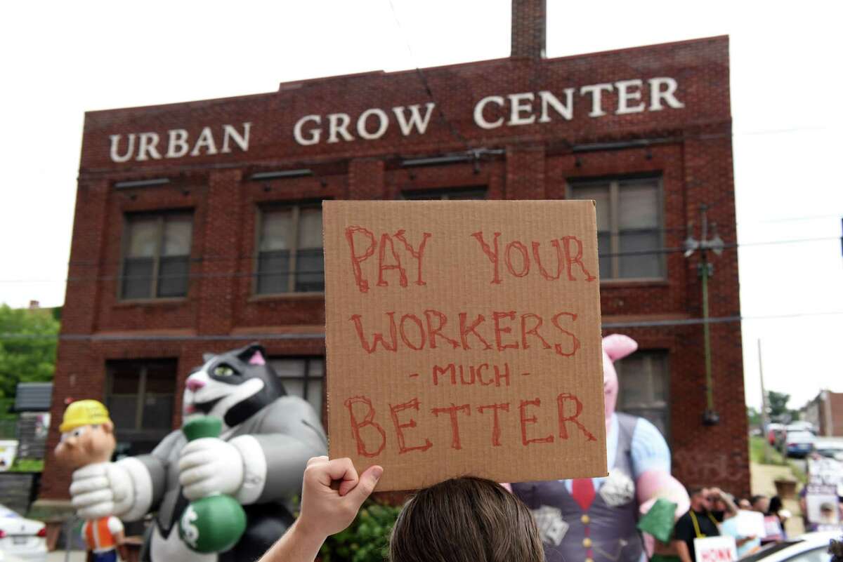 Labor advocates and workers protest outside Capital Roots’ Urban Grow Center on Friday, Aug. 5, 2022, in Troy, N.Y. 