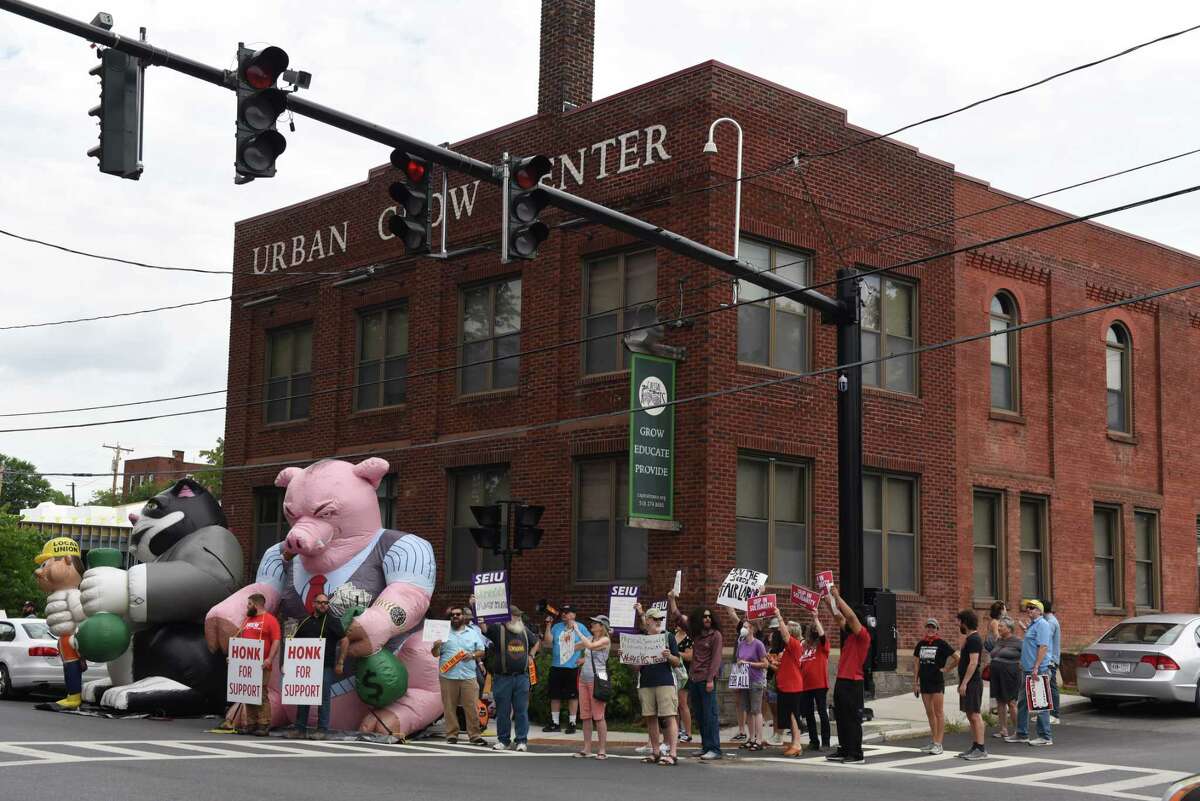 Labor advocates and workers protest outside Capital Roots’ Urban Grow Center on Friday, Aug. 5, 2022, in Troy, N.Y. 