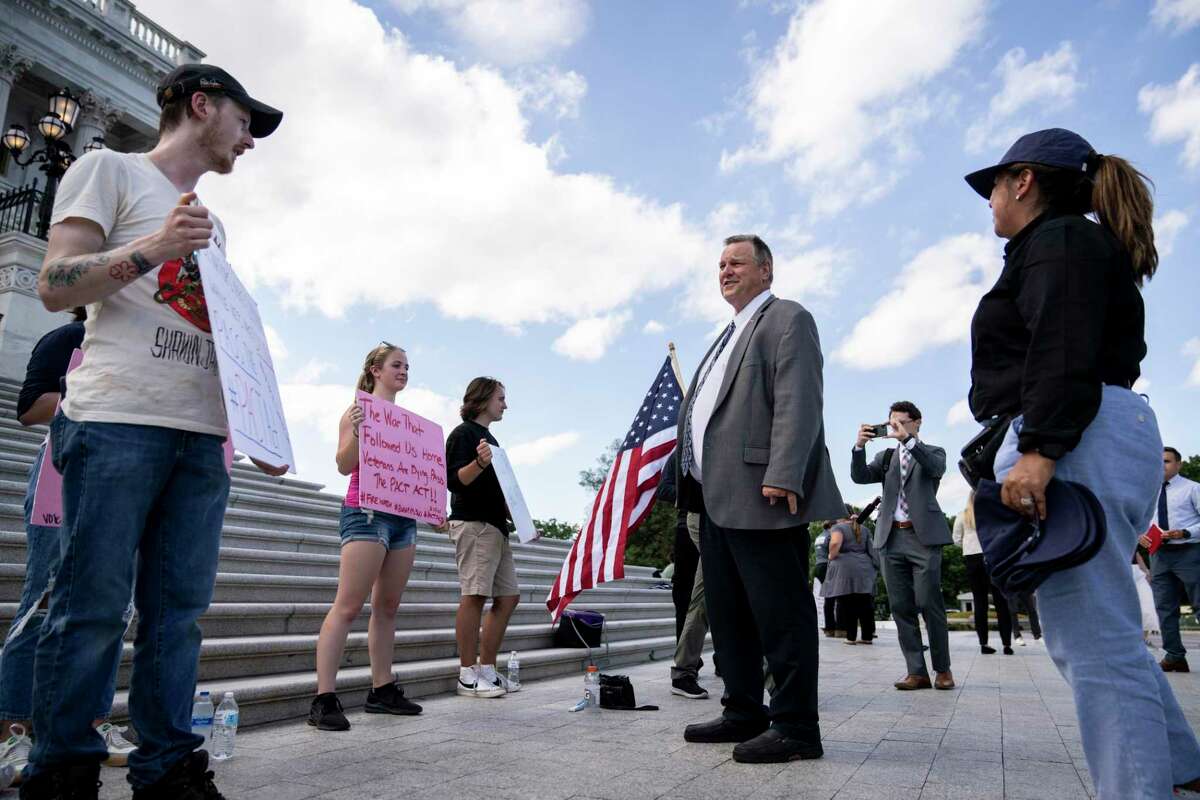 U.S. Sen. Jon Tester, D-Mont., talks with veterans and families in support of the PACT Act. At long last, Congress has passed the legislation, but politics still tarnished the achievement.