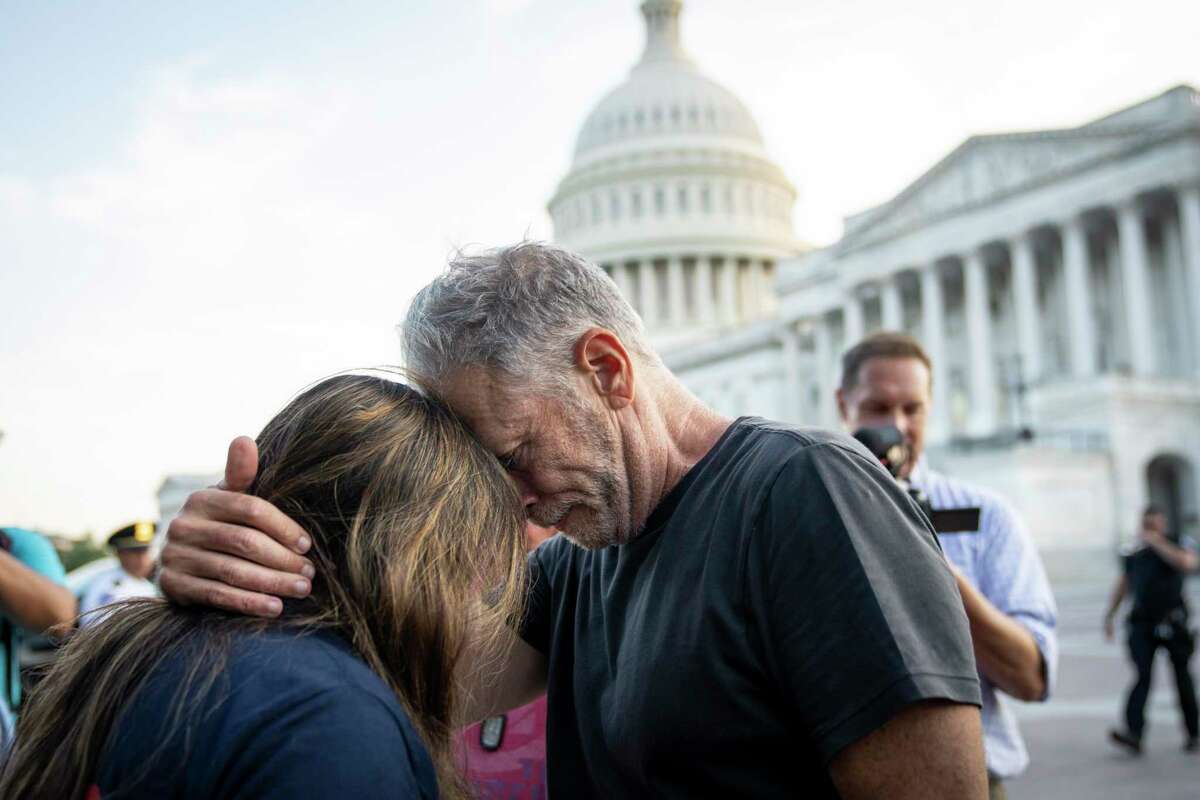 Comedian and activist Jon Stewart hugs Rosie Torres, wife of veteran Le Roy Torres, who suffers from illnesses related to burn pit exposure, after the Senate passed the PACT Act. Determined supporters made it happen.