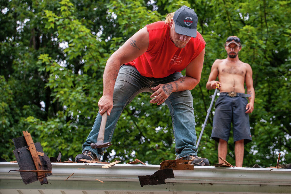 Nick Hale, co-owner of Skills for Tomorrow Remodeling, works on a roof replacement project on Aug. 4, 2022 in the Midland area.