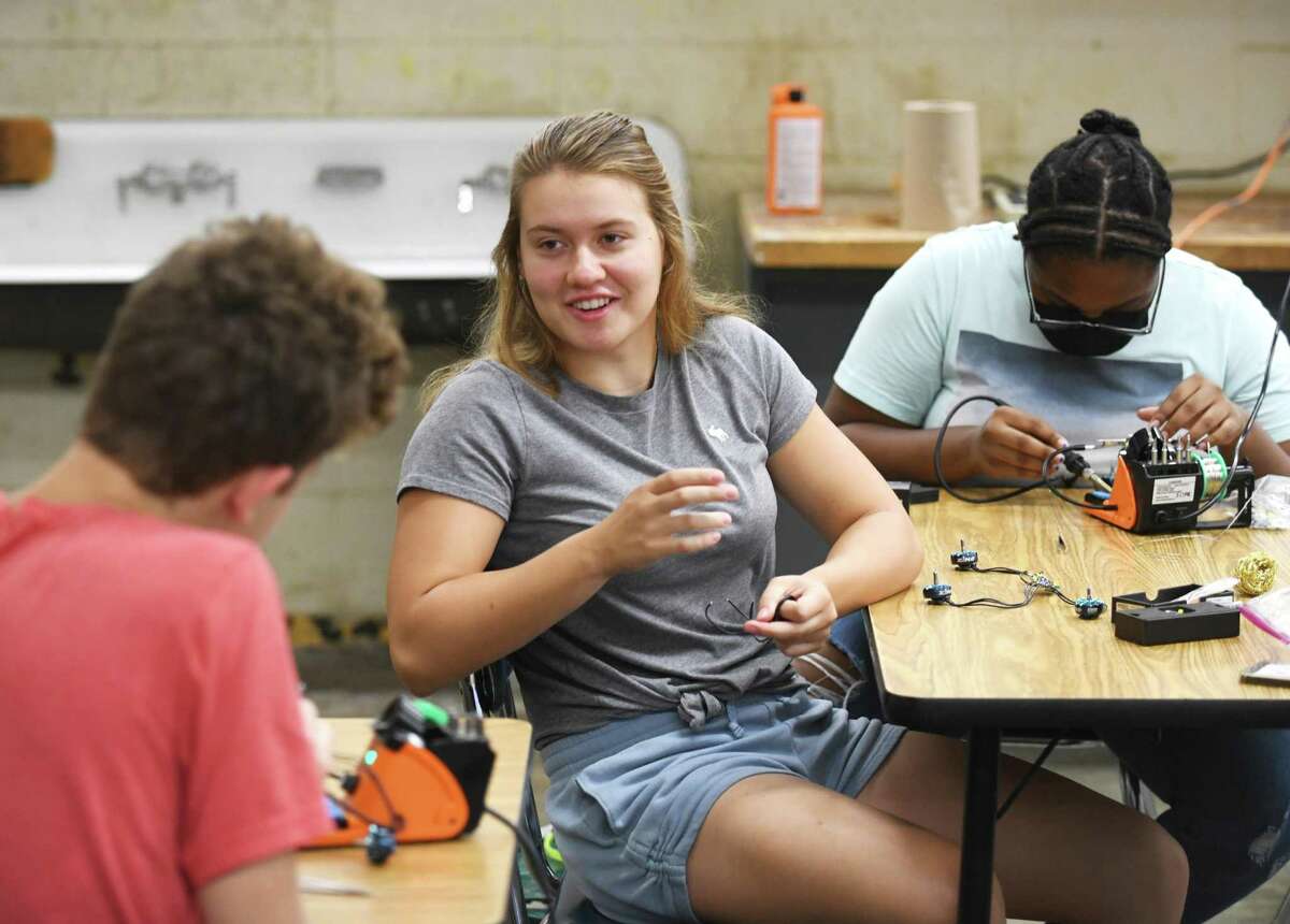 Rising sophomore Olivia Cieciwa works during a shop summer school class at Westhill High School in Stamford, Conn. Monday, July 25, 2022. Students are making a drone during the summer class, which is a gateway for the school system's "career pathways" program set to launch in the fall.