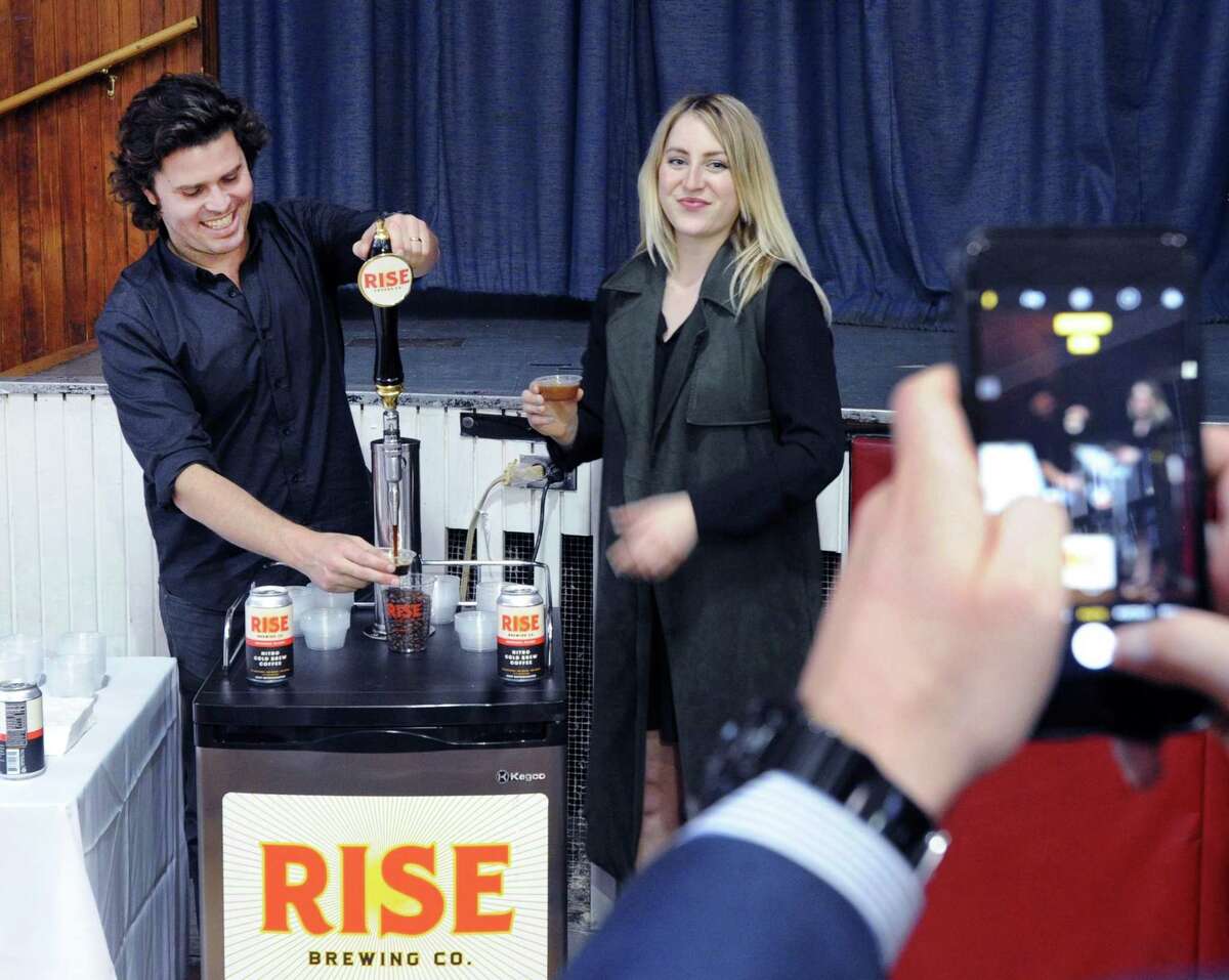 Rise Brewing co-founder Jarrett McGovern, left, and colleague Paige Heeter give out samples during the Greenwich Chamber of Commerce Business Showcase at the Greenwich Civic Center in Old Greenwich, Conn., on April 20, 2017.