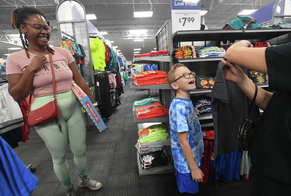 Step-mom Aaryn Davis laughs as Liam Gutierrez checks out a t-shirt his mom Kristen Hale found for him during a back to school shopping spree for 25 Beaumont ISD students at Academy Sports + Outdoors Friday. Photo made Friday, August 5, 2022. Kim Brent/The Enterprise