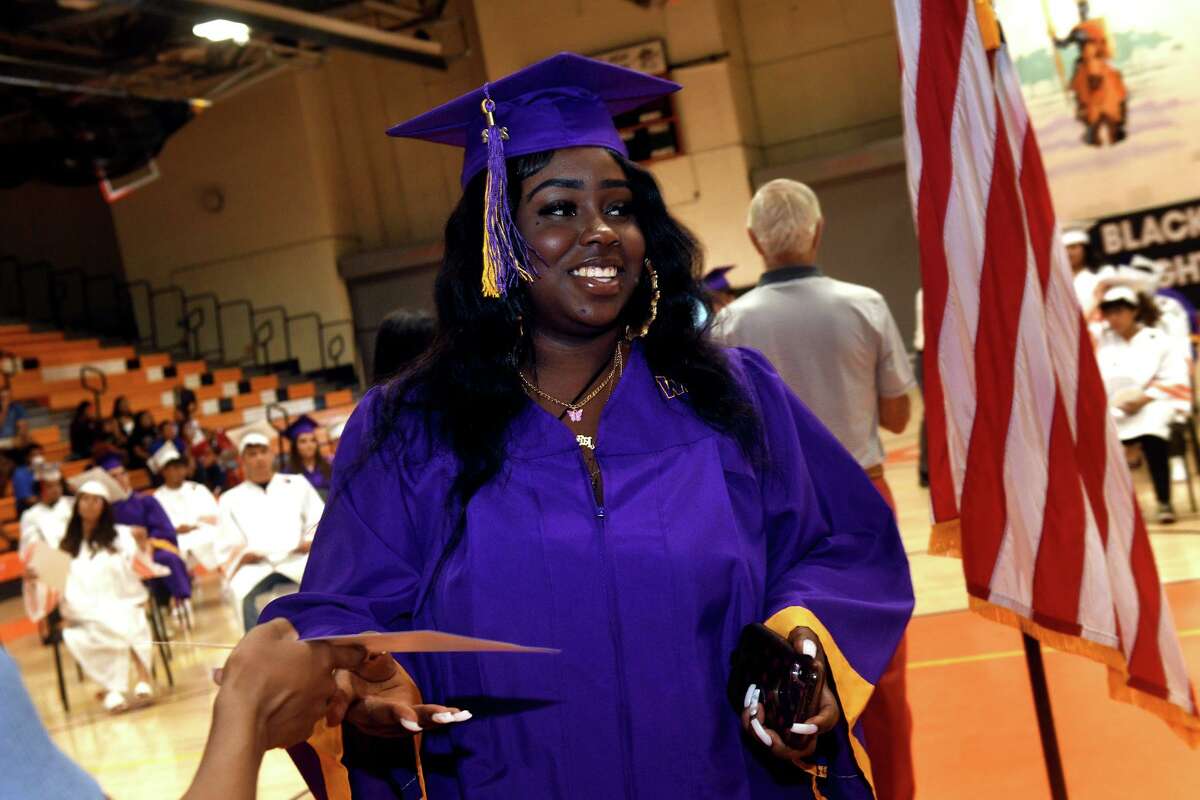 Rose Geffrard from Westhill High School receives her certificate of completed courses during a graduation ceremony for summer high school in Stamford on Friday.