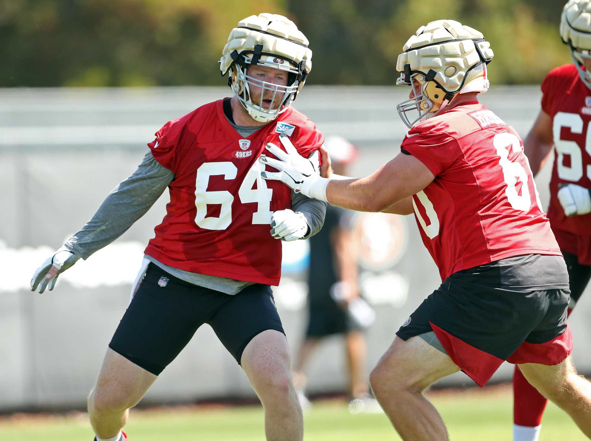 San Francisco 49ers offensive line coach Chris Foerster, top, gestures over  guard Daniel Brunskill at NFL football training camp in Santa Clara,  Calif., Tuesday, Aug. 10, 2021. (AP Photo/Jeff Chiu Stock Photo 