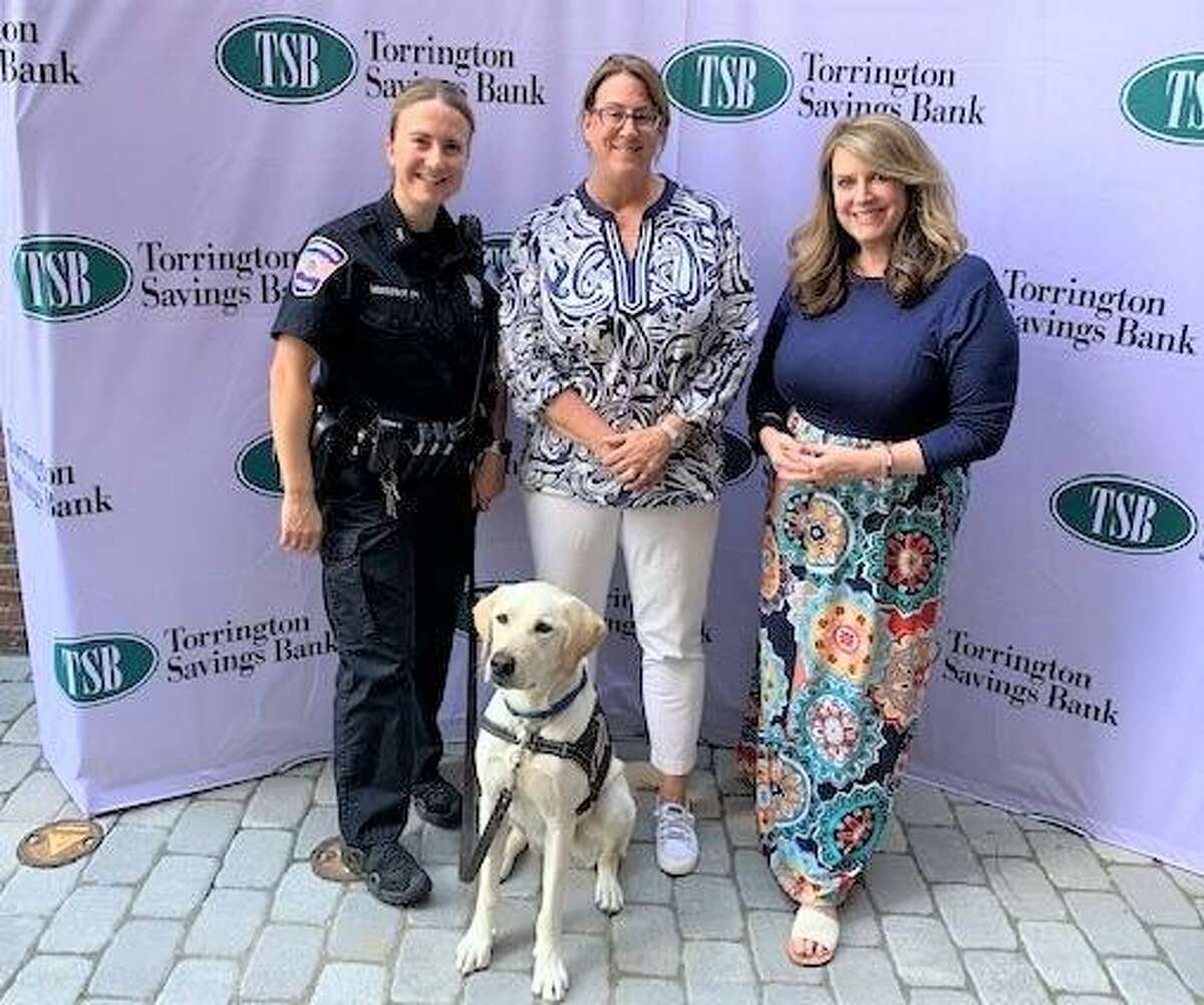 From left are Torrington PD Officer Hannah Yabrosky, TSB President & CEO, Lesa Vanotti, and Renee DiNino, iHeart Radio. In front, K9 Officer Addison.
