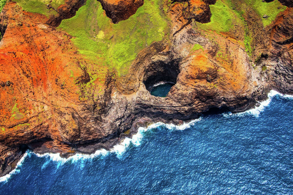 An aerial view of the Napali Coast's open-ceiling cave from the air. Small tour boats can enter the cave, depending on conditions.