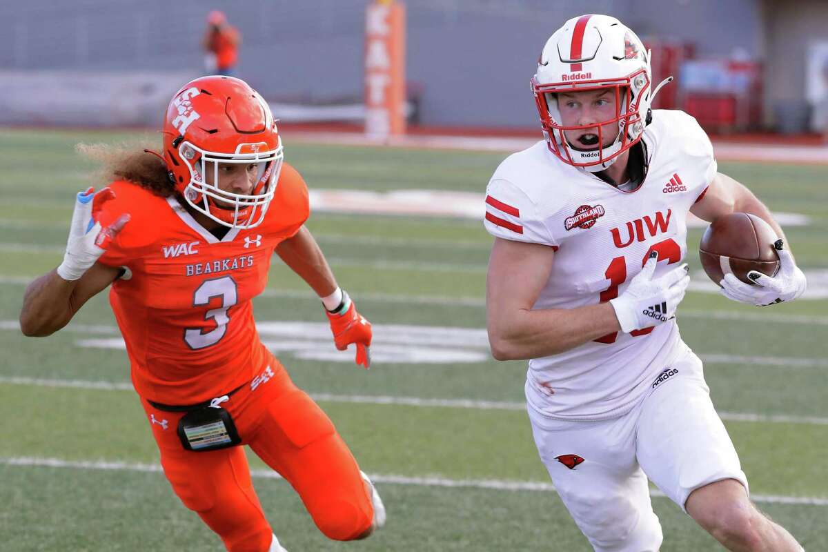 Incarnate Word receiver Taylor Grimes, right, makes a gain in front of Sam Houston defensive back Trey Smith (3) during the first half of a football game Saturday, Dec. 4, 2021 in Huntsville, TX.