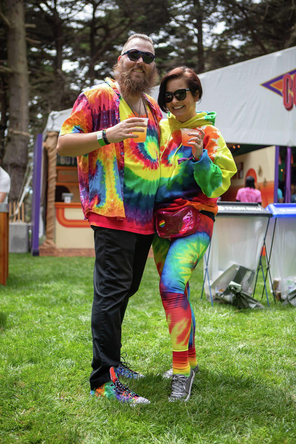Jake Ward and Claudine Bibeau are seen in colorful outfits at the Golden Gate Park Outlands on August 5, 2022 in San Francisco, California.