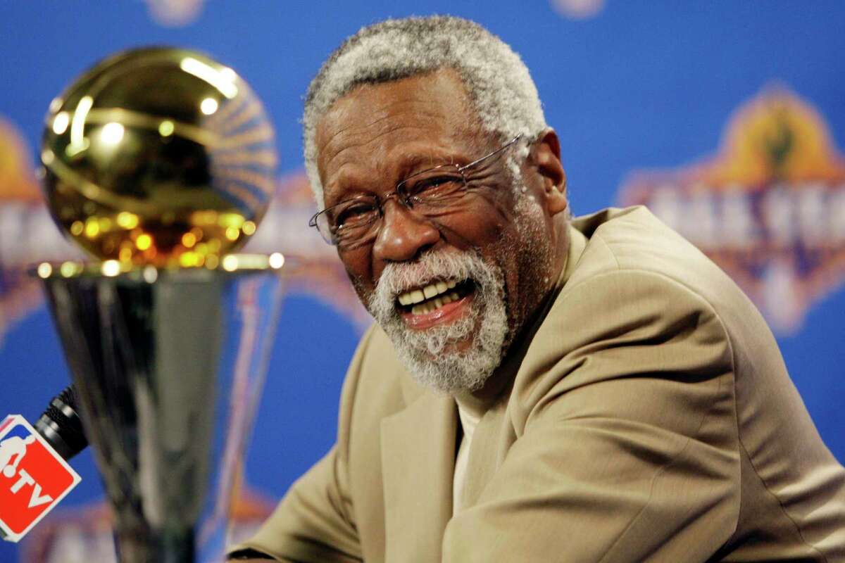 FILE - NBA great Bill Russell reacts at a as he learns the most valuable player award for the NBA basketball championships has been renamed the Bill Russell NBA Finals Most Valuable Player Award during a news conference Feb. 14, 2009 in Phoenix. Basketball fans hoping to buy something from Bill Russell’s memorabilia collection should expect some big-name competition. Hall of Famers Shaquille O’Neal and Charles Barkley say they're interested in bidding on items that Russell — a civil rights icon and the most decorated champion in team sports history — is selling off. An online auction with 429 lots began last week and will culminate in a live event at the TD Garden on Friday, Dec. 10, 2021 (AP Photo/Matt York, File)