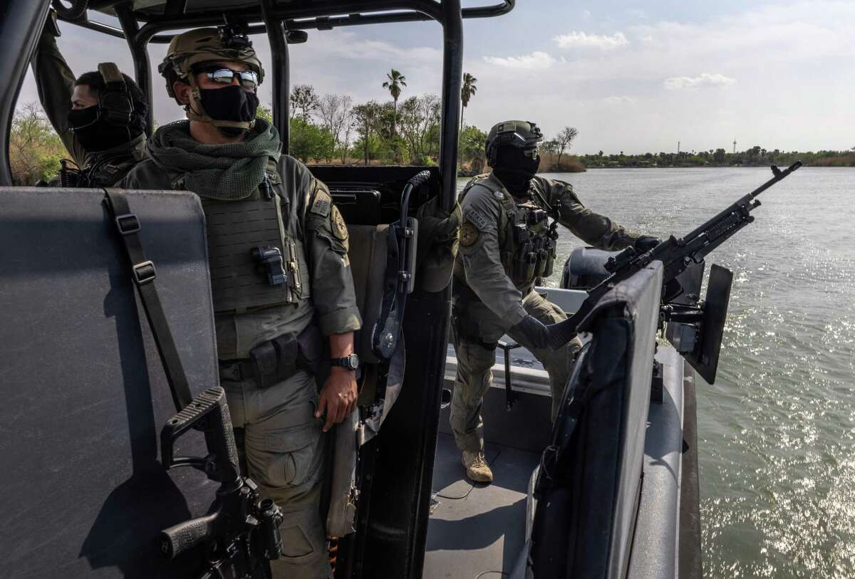 Members of the Texas Department of Public Safety's Tactical Marine Unit patrol the Rio Grande along the U.S.-Mexico Border on March 23, 2021 near Mission, Texas. Texas DPS troopers are taking part in Operation Lone Star in supporting U.S. Border Patrol agents to "deny Mexican Cartels and other smugglers the ability to move drugs and people into Texas." (Photo by John Moore/Getty Images)