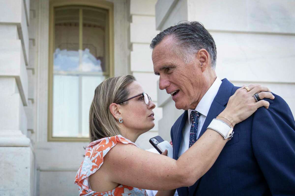 WASHINGTON, DC - AUGUST 4: (L-R) Sen. Kyrsten Sinema (D-AZ) talks with Sen. Mitt Romney (R-UT) outside the U.S. Capitol August 4, 2022 in Washington, DC. Negotiations continue on the Senate budget reconciliation deal, which Senate Democrats have named The Inflation Reduction Act of 2022. The bill is expected to include $370 billion on energy and climate spending, roughly $300 billion in deficit reduction, three years of subsidies for Affordable Care Act premiums, some prescription drug reforms and tax modifications. (Photo by Drew Angerer/Getty Images)