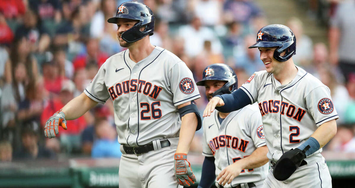 Trey Mancini #26 of the Houston Astros celebrates with Alex Bregman #2 and Jose Altuve #27 after Mancini hit a grand slam in the top of the third inning during the game against the Cleveland Guardians at Progressive Field on August 5, 2022 in Cleveland, Ohio. (Photo by Lauren Bacho/Getty Images)