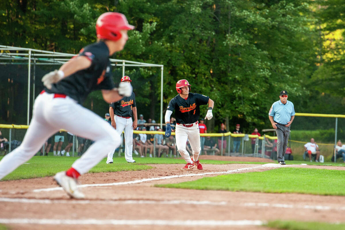 Berryhill Post 165's Braylen Laverty prepares to score from third base on an RBI single by Jack Bakus (foreground) during Friday's game against Gladwin Post 171 in the American Legion Baseball Great Lakes Region tournament at Northwood, Aug. 5, 2022.