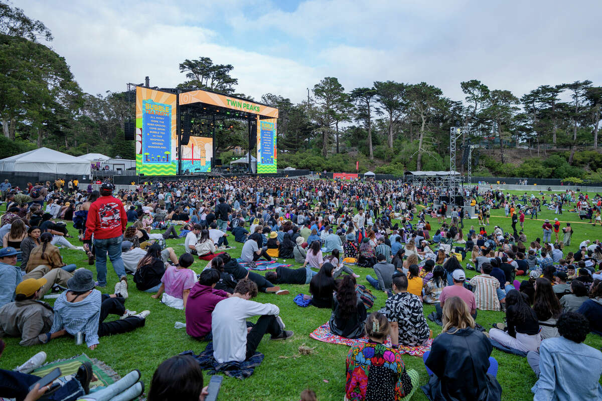 Attendees sit along the grassy hill at the Twin Peaks stage where The Marias would soon perform at Outside Lands in Golden Gate Park in San Francisco, Calif. on Friday, Aug. 5, 2022.