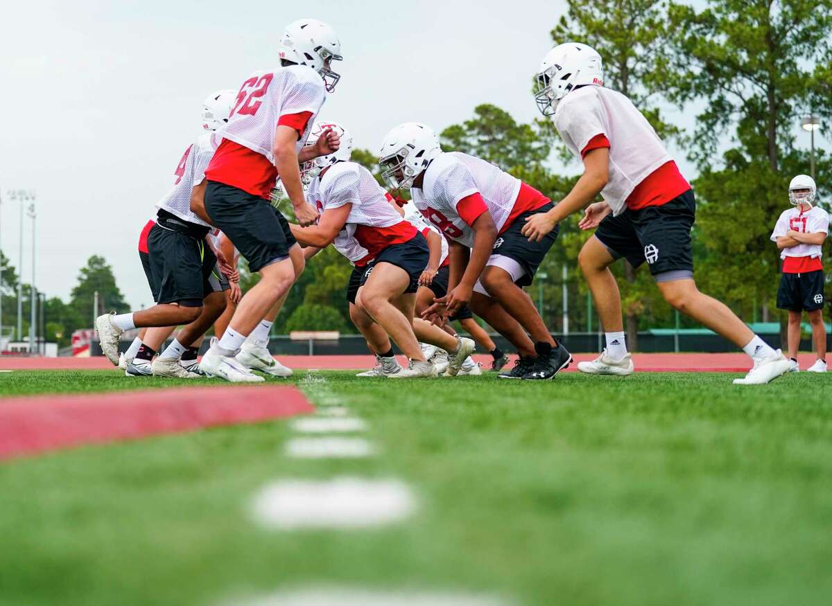 Varisty players run plays during football practice at Tomball High School on Friday, Aug. 5, 2022 in Tomball.