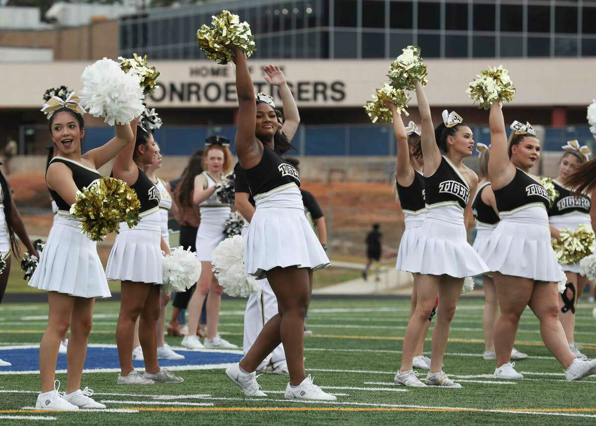 Conroe cheerleaders pump up the crowd during Meet the Tigers at Buddy Moorhead Stadium on Friday in Conroe. Community members saw performances by the Conroe High School’s band, Golden Girls, cheerleaders and stayed to watch the football team practice under the lights.