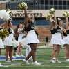 Conroe cheerleaders pump up the crowd during Meet the Tigers at Buddy Moorhead Stadium on Friday in Conroe. Community members saw performances by the Conroe High School’s band, Golden Girls, cheerleaders and stayed to watch the football team practice under the lights.