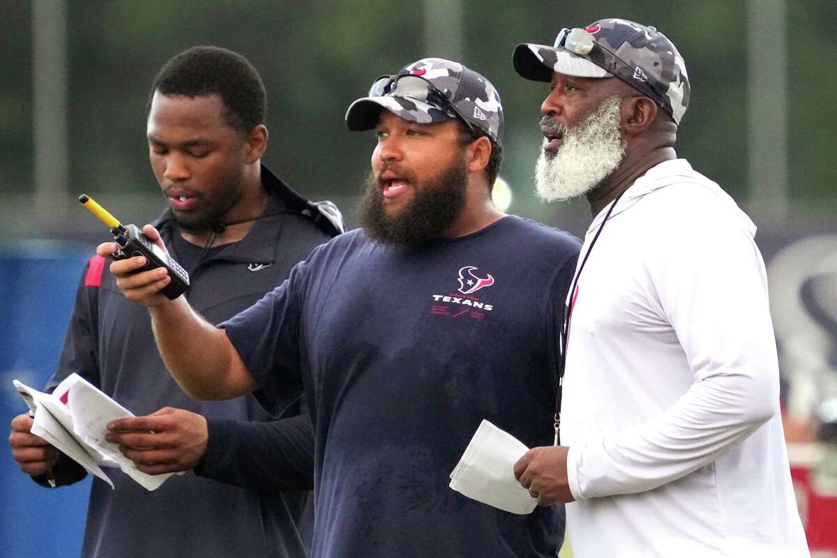 Miles Smith, center, is similar to Lovie in many ways as a coach with the exception of the color their beards.