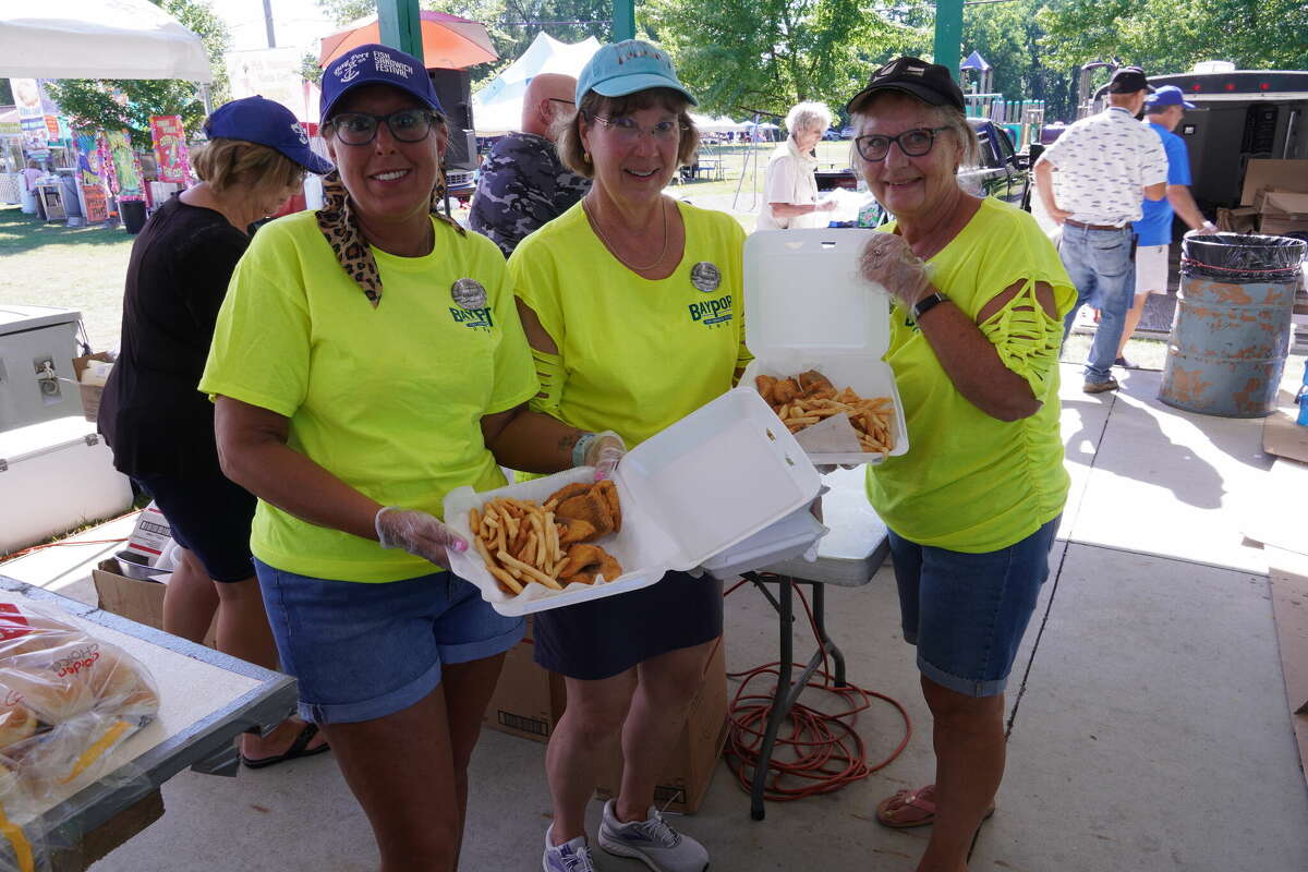Volunteers showing off the sandwiches at the pavilion.