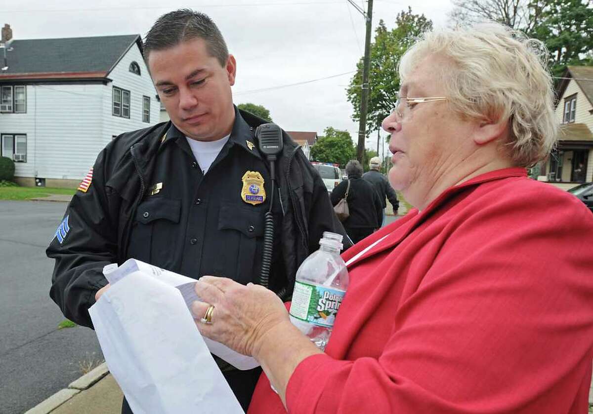 Jeanne Kippen, Ruling Elder for the Church, shows the deed for the church to Watervliet Police Sergeant Patrick Donlon as the members and trustees of Jermain Memorial Ecumenical Presbyterian Church gather at the church in Watervliet, NY on October 5, 2010. The members have been battleing Albany Presytery over the church property, which includes a legacy fund. (Lori Van Buren / Times Union)