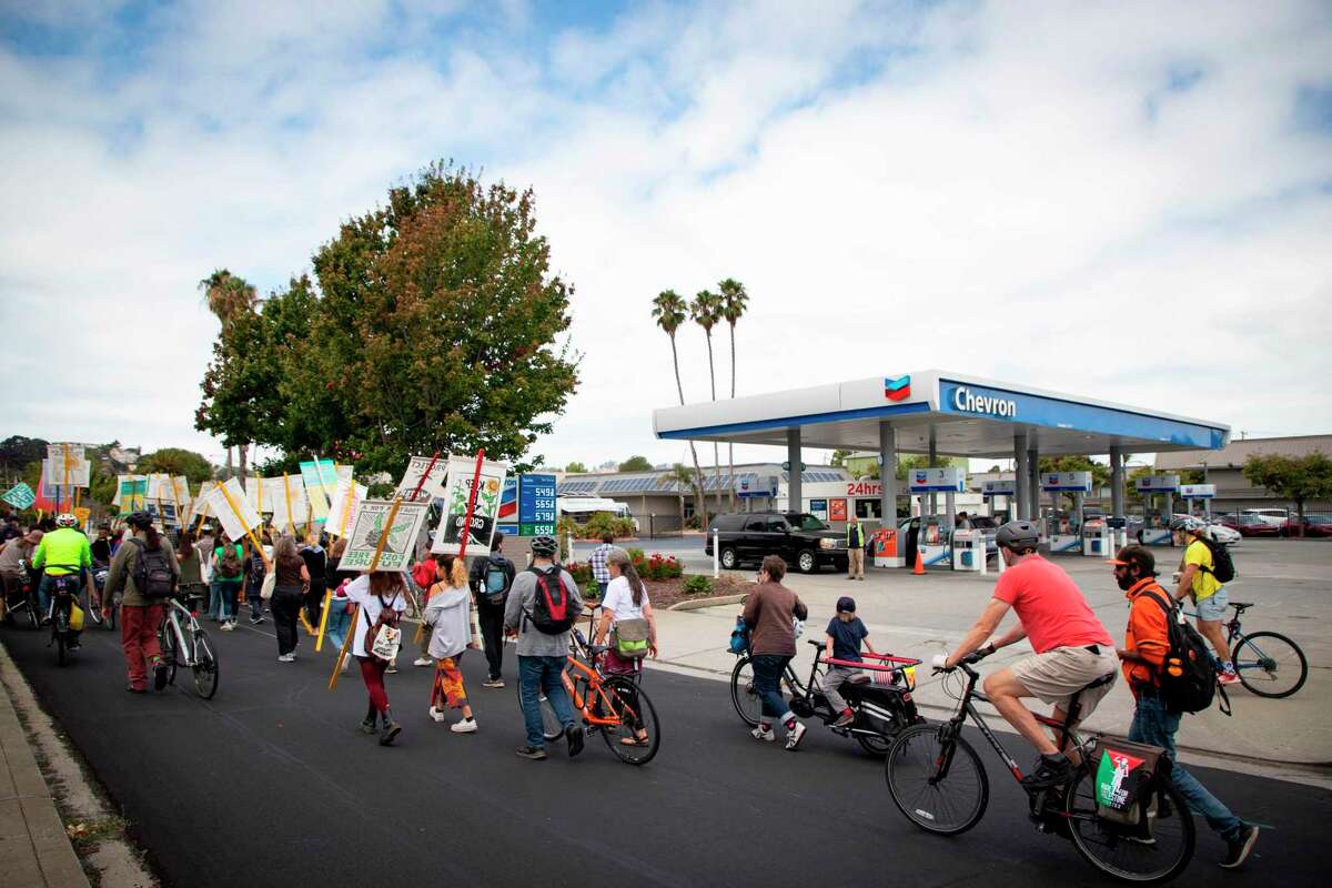 Protesters march to the Chevron Refinery in Richmond on Saturday. The march, led by Richmond Our Power Coalition, commemorates the 10th anniversary of the explosion at the refinery.