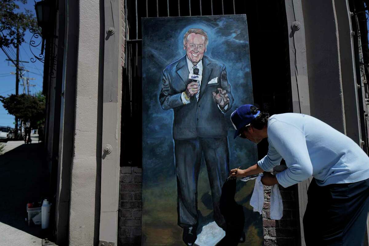 Artist Nicholas Gagliarducci paints a portrait of broadcaster Vin Scully near Dodger Stadium.