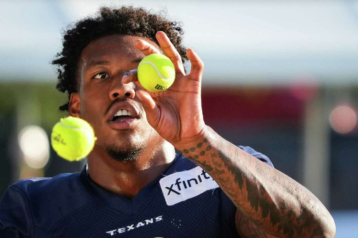 Houston Texans tight end Brevin Jordan works on his hand-eye coordination using a pair of tennis balls during an NFL training camp Sunday, Aug. 7, 2022, in Houston.
