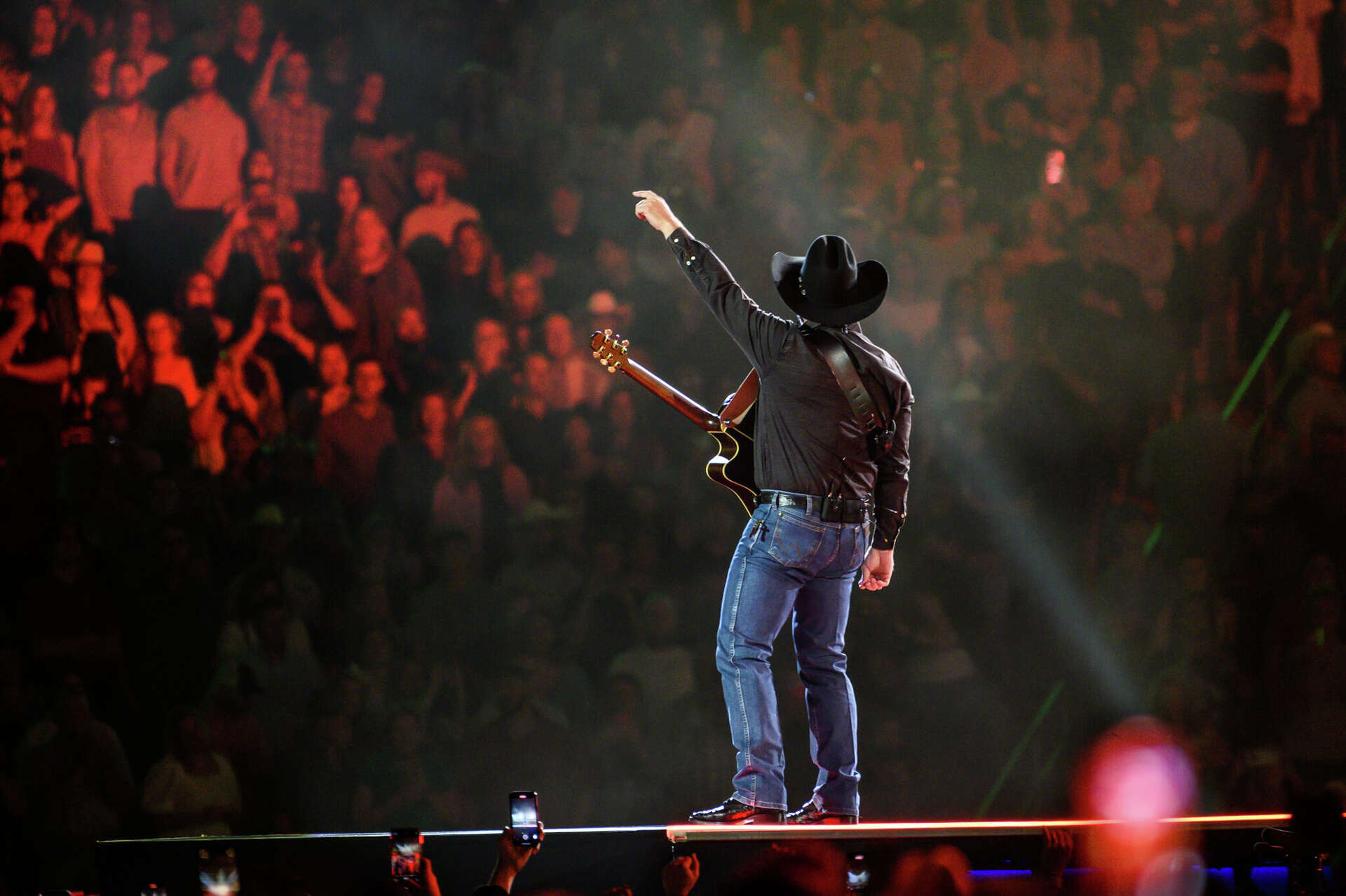 The country superstar appeared from underneath a levitating drum set, his arms above his head as if he were lifting it into the air.