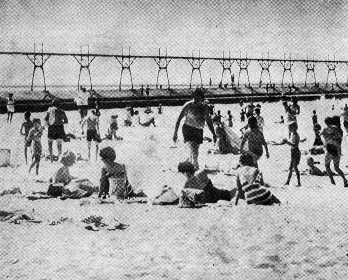 Hundreds of people flocked to local beaches yesterday as the high water and air temperatures created enticing summer weather. Yesterday's Lake Michigan temperature is a season high of 74 degrees while the air temperature was 82 degrees. The photo was published in the News Advocate on Aug. 7, 1962.