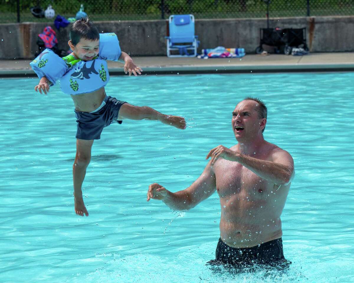 Chris Martin tosses Nicky Martin into the Colonie Town Pool on Sunday, Aug. 7, 2022. (Jim Franco/Special to the Times Union)