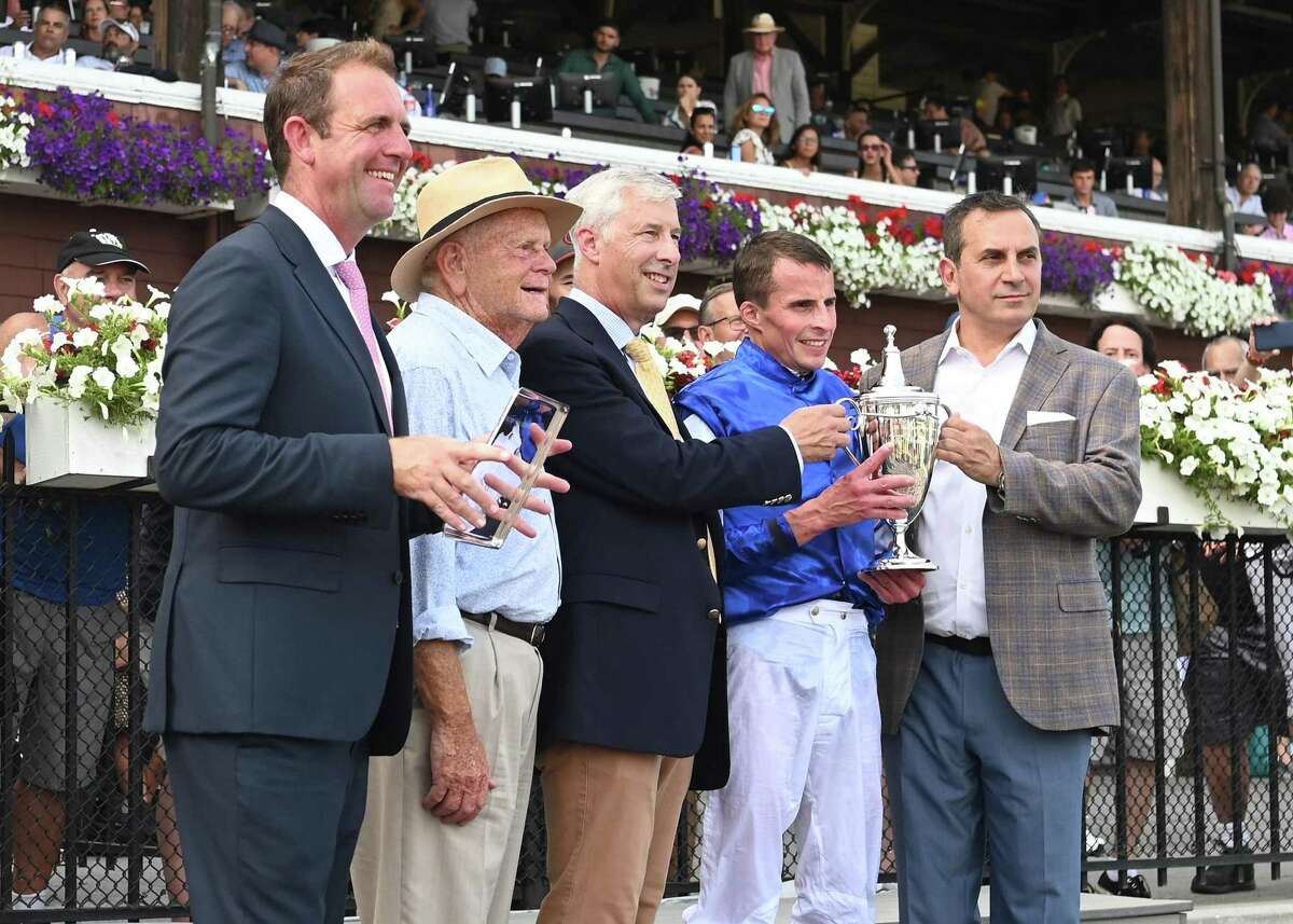 Trainer Charles Appleby, associates of Godolphin, LLC., and jockey William Buick pose with the trophy from their victory in the Saratoga Oakes Invitational at Saratoga Race Course on Sunday, Aug. 7, 2022, in Saratoga Springs, N.Y. (Jenn March, Special to the Times Union)