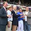 Trainer Charles Appleby, far left, connections of Godolphin, LLC., and jockey William Buick, second from right, pose with the trophy from their victory in the Saratoga Oakes Invitational at Saratoga Race Course on Sunday, Aug. 7, 2022, in Saratoga Springs, N.Y. (Jenn March, Special to the Times Union)