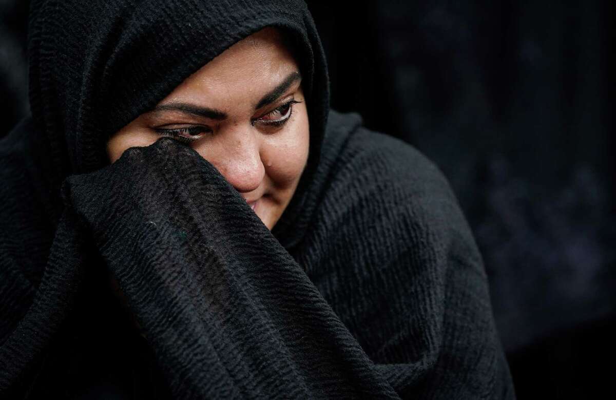 Sahar Naqvi cries as she listens to a eulogy for Imam Husayn ibn Ali on Saturday, Aug. 6, 2022, in downtown Houston. Hundreds of Shiite Muslims gathered to remember Imam Husayn’s martyrdom around 1350 years ago with prayer, eulogies and a procession through downtown. “It tells me a story of bravery, and it tells me to resist the force of tyranny,” she said.