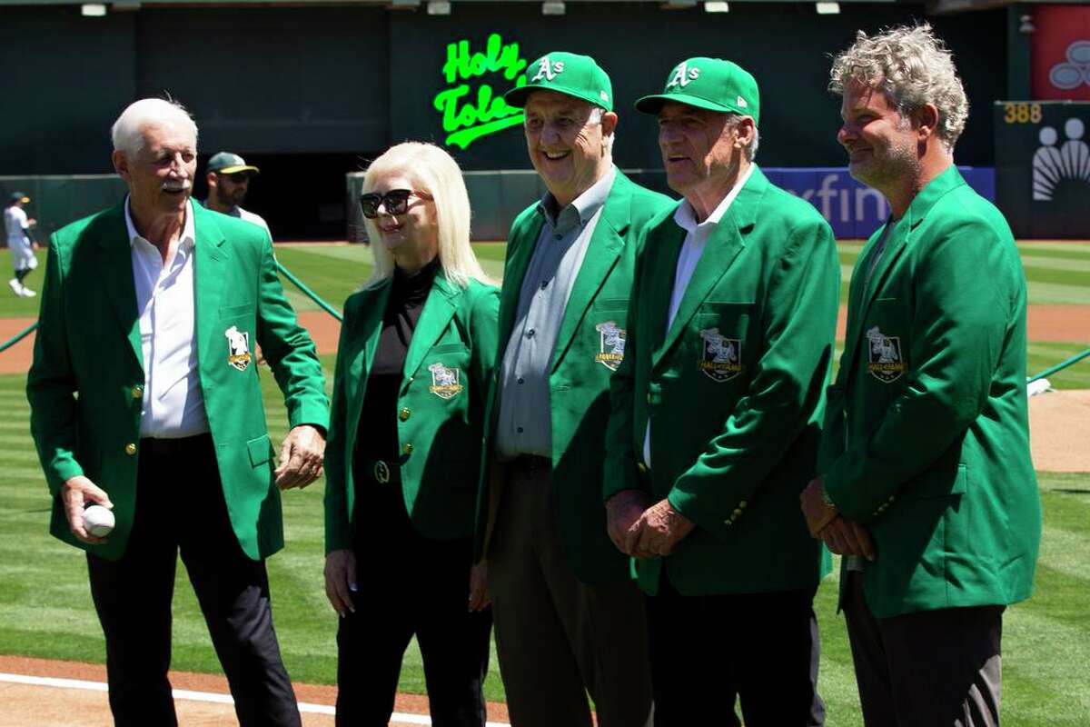 Newly inducted members of the Oakland Athletics Hall of Fame pose for a photo before a baseball game against the San Francisco Giants, Sunday, Aug. 7, 2022, in Oakland, Calif. From left to right, Joe Rudi, Carol Fosse, widow of inductee Ray Fosse, long-time equipment manager Steve Vucinich, long-time A's director of player development Keith Lieppman, and Sal Bando Jr., son of inductee Sal Bando. (AP Photo/D. Ross Cameron)