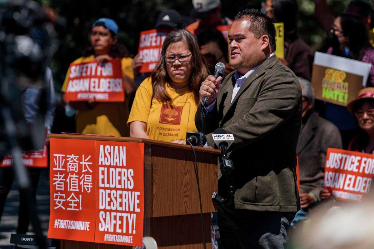 San Francisco Police Commissioner Keven Benedicto joins volunteer leader Christina Chen at the Defend Asian Elders rally at Washington Square Park in San Francisco.