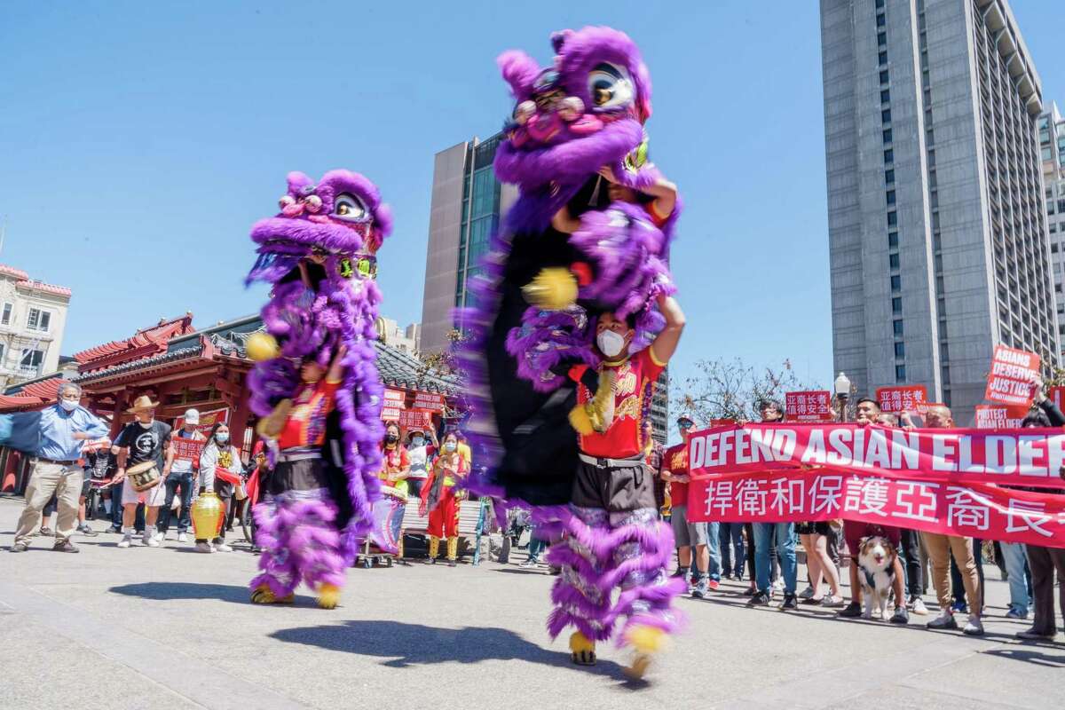 Lion dancers join the Defend Asian Elders rally at Portsmouth Square in San Francisco.