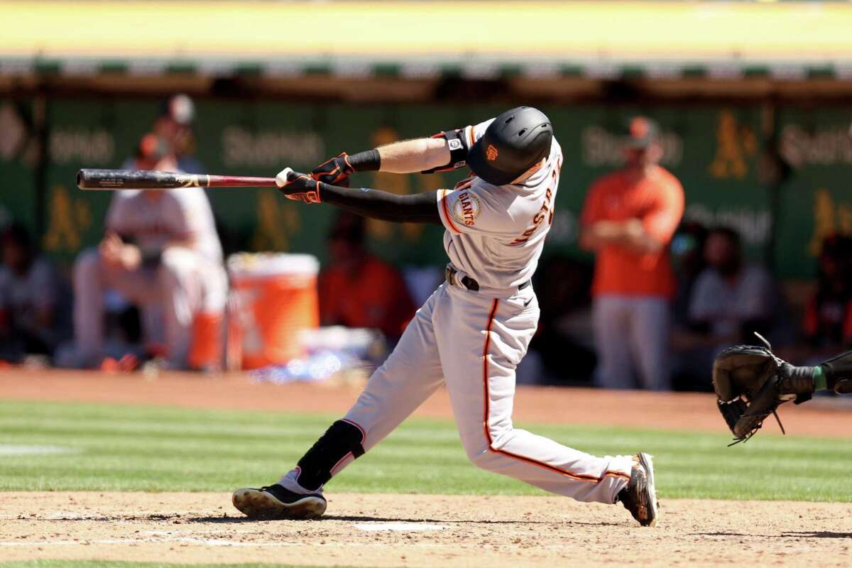 OAKLAND, CALIFORNIA - AUGUST 07: Mike Yastrzemski #5 of the San Francisco Giants hits his second home run of the game, this one in the eighth inning, against the San Francisco Giants at RingCentral Coliseum on August 07, 2022 in Oakland, California. (Photo by Ezra Shaw/Getty Images)
